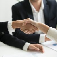 Business owner agreeing terms with an agency to outsource link building