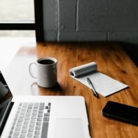 Writer at a laptop working on SEO copywriting services after a site audit