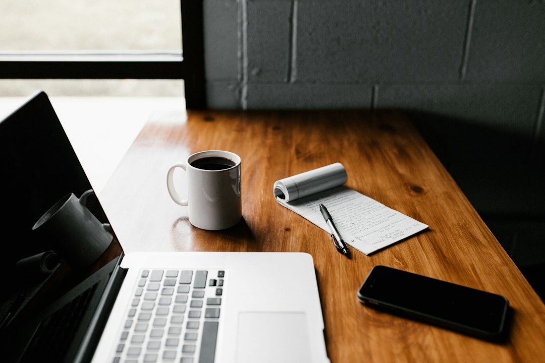 Writer at a laptop working on SEO copywriting services after a site audit