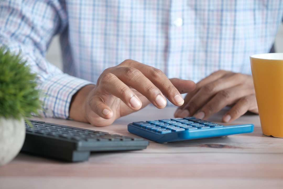 Business owner using a calculator to compare affordable SEO packages and monthly costs