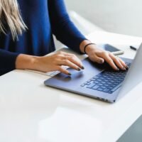 Marketer writing a personalised email for link building outreach on a laptop