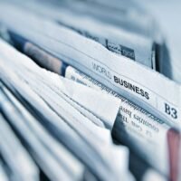 Newspaper pages representing press coverage earned through off page SEO services
