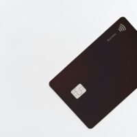 Business credit card on a white desk, illustrating the Ahrefs price and subscription costs