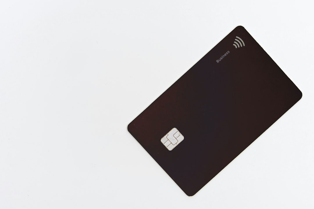 Business credit card on a white desk, illustrating the Ahrefs price and subscription costs