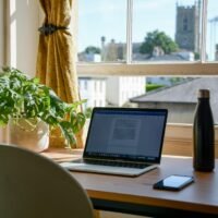 SEO freelancer at a home desk, weighed against the best SEO company UK businesses can hire