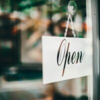 Open for business sign at a shop that local SEO companies help get found in Google Maps
